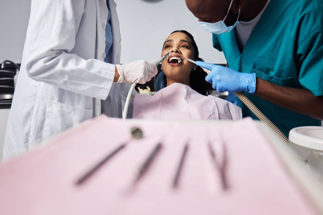 Woman shows bright smile during dental procedure