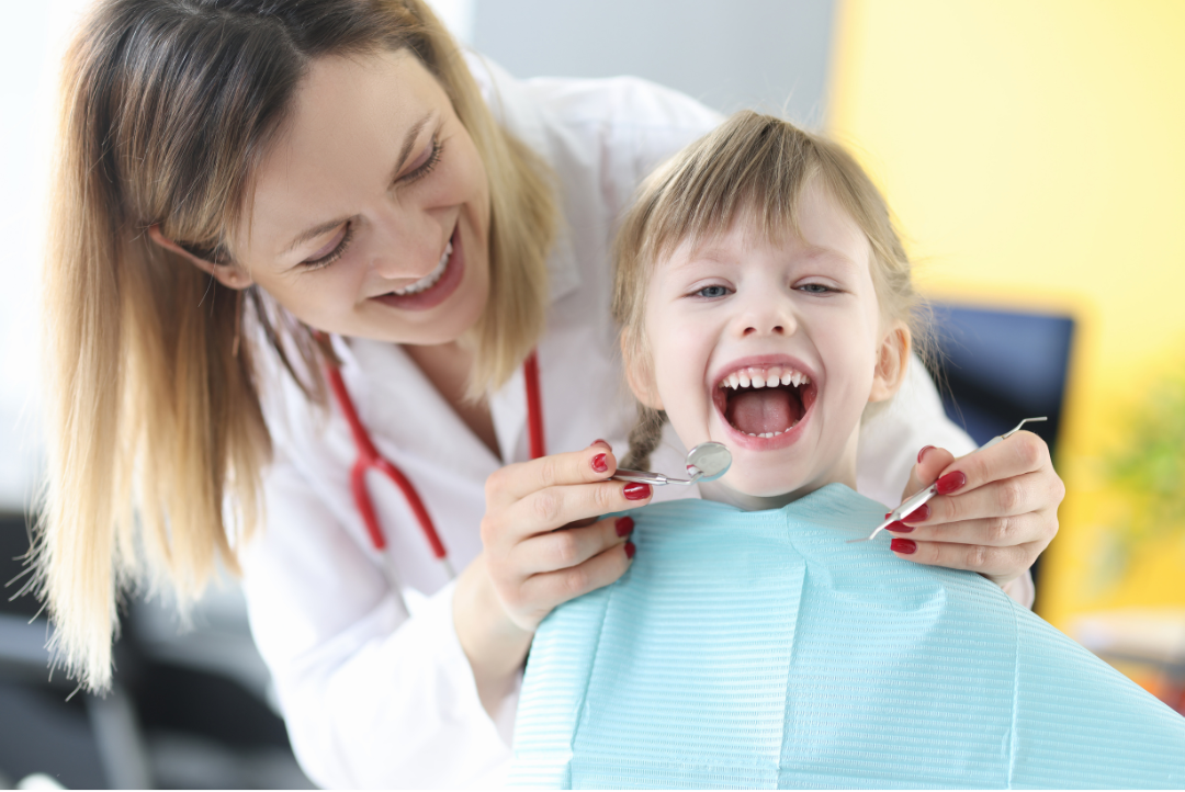 Pediatric dental patient smiles during exam
