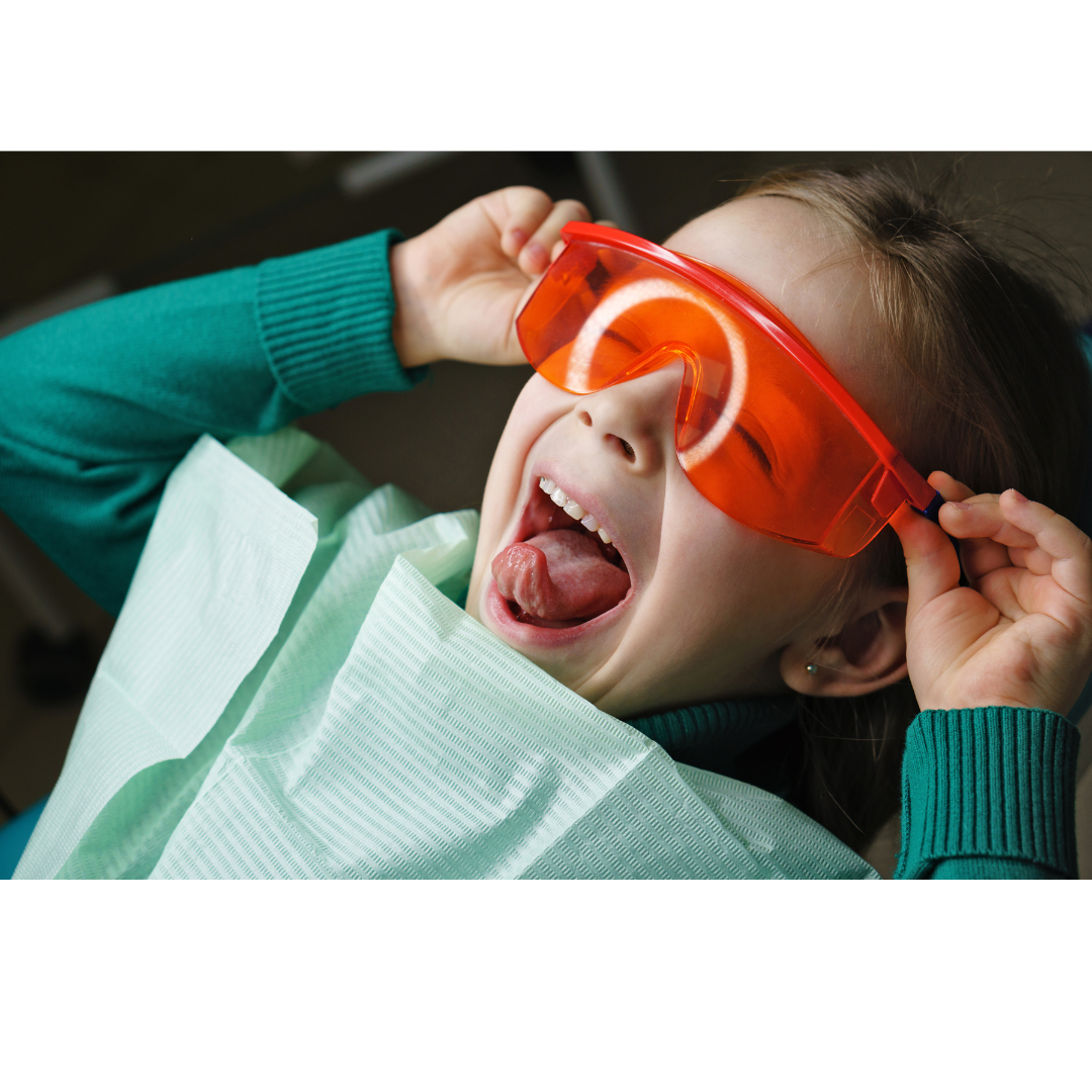 Child happy during a dental procedure at Ames Dentistry