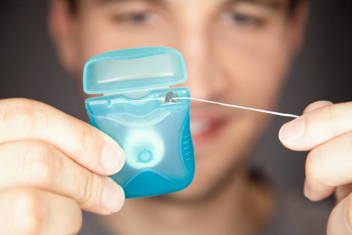 Flossing teeth leads to good oral health